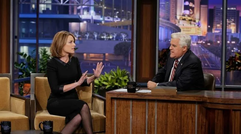 Savannah Guthrie laughing during a late-night talk show interview